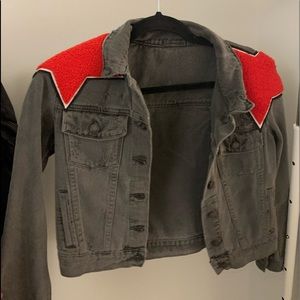 Black distressed jean jacket with red stars